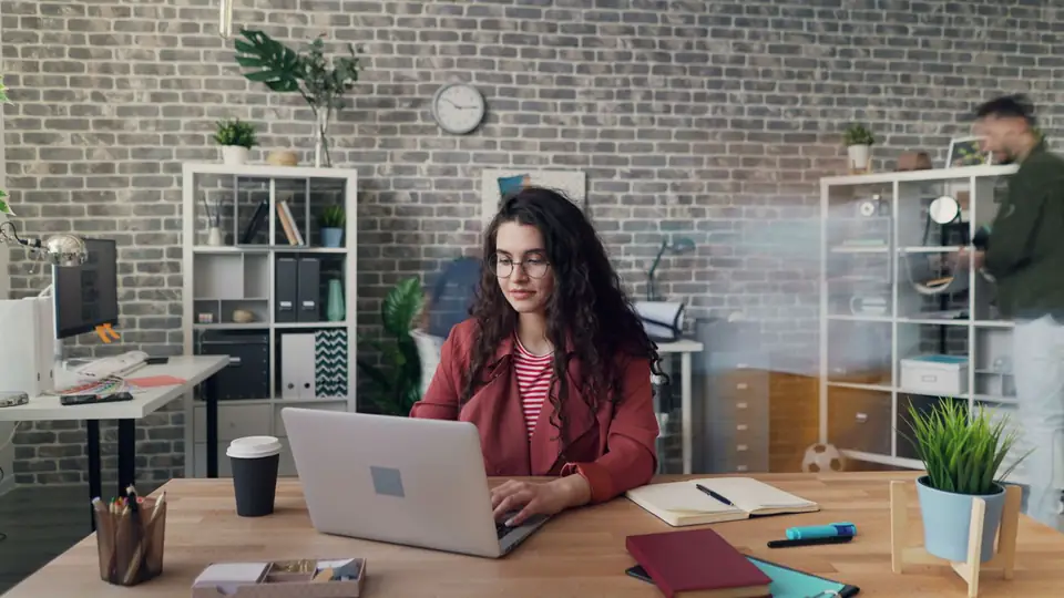 Small business owner working at a laptop in a shared office